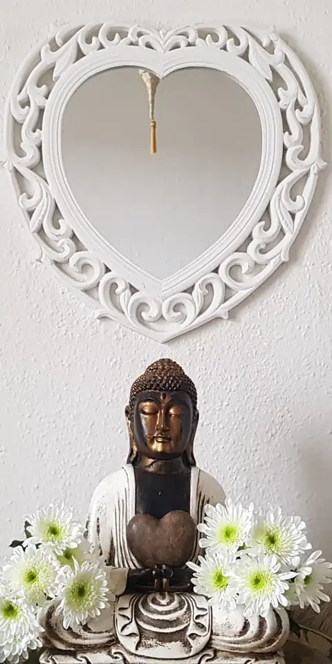 Buddha-Figur mit weissen Blumen